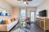 San Mateo Apartments Kissimmee Florida living room with vinyl plank flooring, french patio door, and ceiling fan
