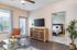 San Mateo Apartments Kissimmee Florida living room with vinyl plank flooring, french patio door, and ceiling fan