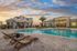 San Mateo Apartments Kissimmee Florida sparkling swimming pool with zero entry and lounge chairs by community clubhouse and outdoor kitchen