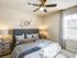 Spacious bedroom large enough to fit a king size bed with soft clean carpet and modern ceiling fan, beautiful natural light.