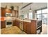 Beautiful kitchen with built-in wine storage, Elegant Silestone Calacatta Quartz Kitchen Countertops. Stainless steel appliances, deep maple cabinetry. Integrated under- cabinet LED lighting