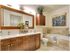 Beautiful spa bathroom with double vanity sinks, custom framed mirror.