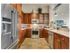 Beautiful kitchen with built-in wine storage, Elegant Silestone Calacatta Quartz Kitchen Countertops. Stainless steel appliances, deep maple cabinetry. Integrated under- cabinet LED lighting