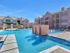 Beautiful Luxury pool with lounge chairs. Beautiful fountains falling into the pool and a small courtyard.