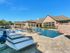 Beautiful Luxury pool with lounge chairs. Beautiful fountains falling into the pool and a small courtyard.
