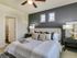 Spacious bedroom large enough to fit a king size bed with soft clean carpet and modern ceiling fan, beautiful natural light.