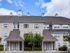 The Henry Apartments, exterior, building, tan building, 3 levels, trees, blue sky