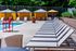 The Henry Apartments, exterior, sparkling blue pool, gray lounge chairs, yellow umbrella at gray table, trees, shaded tent seating