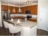 Beautiful modern kitchen with wooden shaker style cabinets and an island with granite countertops