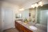 Large bathroom with full length wall mirror and double sinks