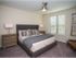 Open and airy carpeted bedroom with modern furnishings
