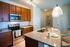 Beautiful modern kitchen with wooden shaker style cabinets and an island with granite countertops