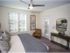 Open and airy carpeted bedroom with modern furnishings