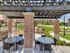 Beautiful view of our large outdoor courtyard. Two outdoor dinning tables with a set of four chairs each. One bbq grill.