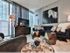 Spacious living room with sofa, tv and floor to ceiling windows