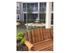 Zen courtyard with a large wooden swing, fountain, and green space l Monterey Pointe