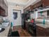 Kitchen with black appliances and espresso cabinets