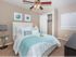 Elegant Master Bedroom with ceiling fan and plush carpet