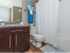 Luxurious Master Bathroom with hardwood floors and espresso cabinets