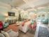 Furnished resident Lounge with television and windows overlooking pool