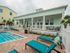 Leasing area back porch facing pool and lounge chairs