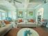 Resident Lounge with couches, coffee table, and ceiling fans hanging from vaulted, beamed ceiling
