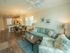 Furnished open-concept living room with ceiling fan, dining room and kitchen