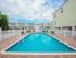 Secondary lap pool with a few chairs and tables