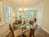 Open concept with furnished dining room and pendant lighting facing living room