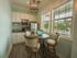 Dinette set in kitchen with upgraded lighting and stainless steel microwave and refrigerator
