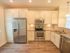Kitchen with cabinets, stainless steel refrigerator, microwave, oven, and dishwasher