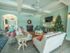 Furnished resident lounge with vaulted beamed ceiling with two ceiling fans