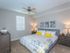 Spacious Bedroom with ceiling fan, large bed with two bed-side tables l High Ridge Landing