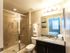 Bathrooms with standing showers, granite countertops, and upgraded lighting l High Ridge Landing in Boynton Beach, FL