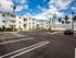 Parking lot, yellow and white building with detached garage parking l High Ridge Landing