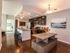 Model home interior of dining room, kitchen with island and seating and looking into the bedroom l High Ridge Landing