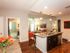Model home showing island kitchen, living room and guest-access bathroom l High Ridge Landing