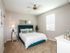 Bedroom with ceiling fan, large bed and beside table l High Ridge Landing