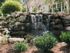 The Henry Apartments, exterior, large stone water fall, house, trees, bushes