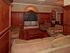 Various cushioned couches surround a coffee table | A large entertainment  |  Mirasol at Celebration