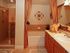Mirasol at Celebration, interior, bathroom, glass door shower stall, soaker tub, tile floor, brown cabinets, large mirror