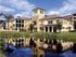 Mirasol at Celebration, exterior, water view, three level building, archways, balconies, grass, trees
