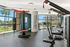 The Strand - Community Fitness Center With a Variety of Equipment, Floor to Ceiling Windows, and Inspirational Wall Decoration