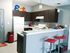Frassati Hall, interior, kitchen, dark cabinets, breakfast bar seating, white appliances, refrigerator, stove/oven, red bar stools