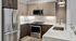 Gourmet Kitchen with SS Appliances, Waterfall Counters & Breakfast Bar