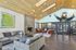 Bright, modern lounge area with cozy seating, a fireplace, and artistic decor.