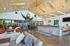 Bright and modern community lounge with wooden vaulted ceilings, comfortable seating, and a welcoming atmosphere.