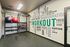 Modern home gym featuring workout equipment with motivational words on the wall.