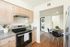 Contemporary kitchen with wooden cabinets, sleek appliances, and adjacent dining space.