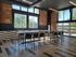 Bright, modern space with exposed brick walls, expansive windows, and sleek flooring, offering a chic industrial vibe and natural sunlight.